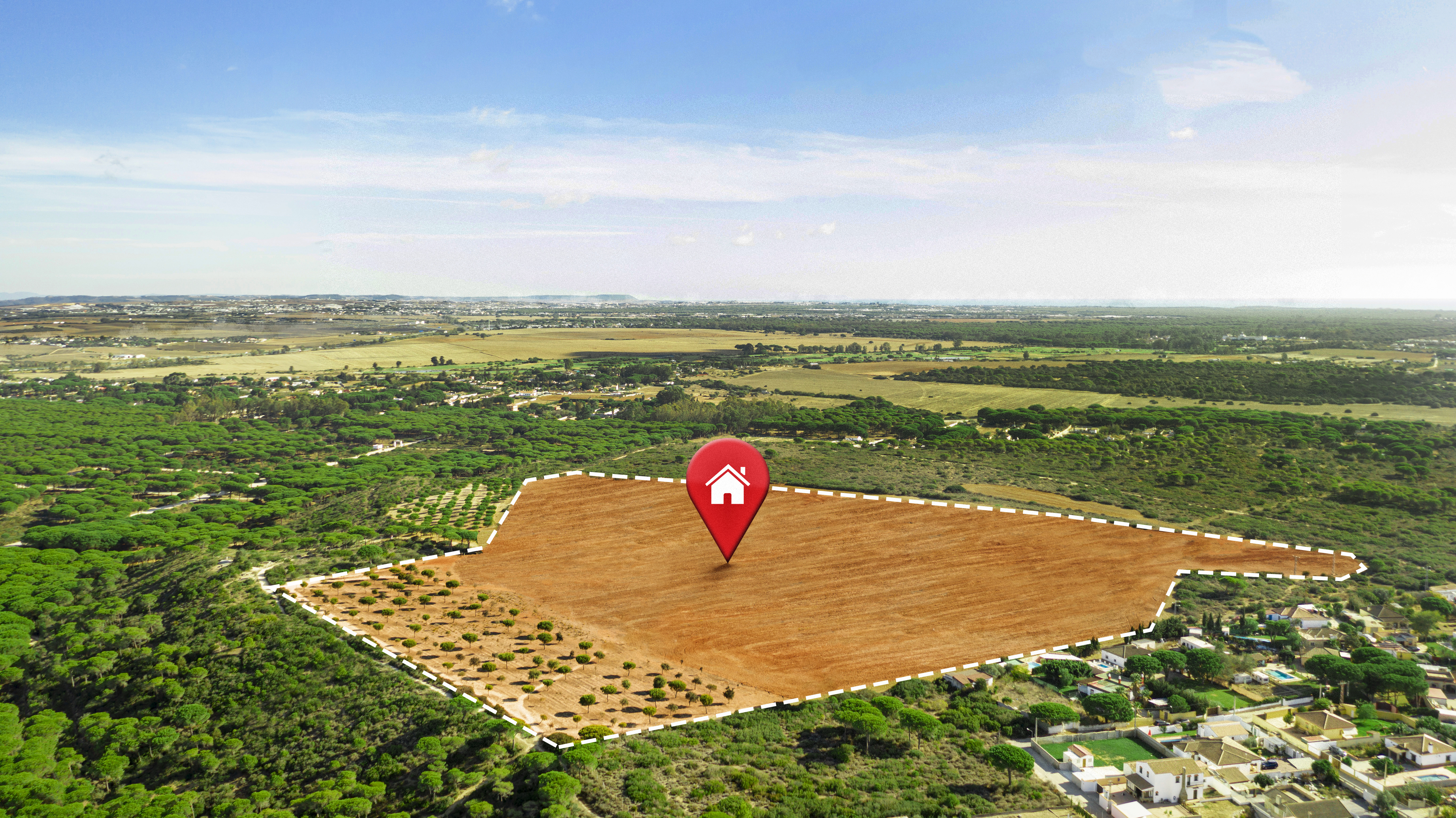 Aerial view of a plot with a home location pin, surrounded by greenery and nearby houses, representing real estate development in Hyderabad.